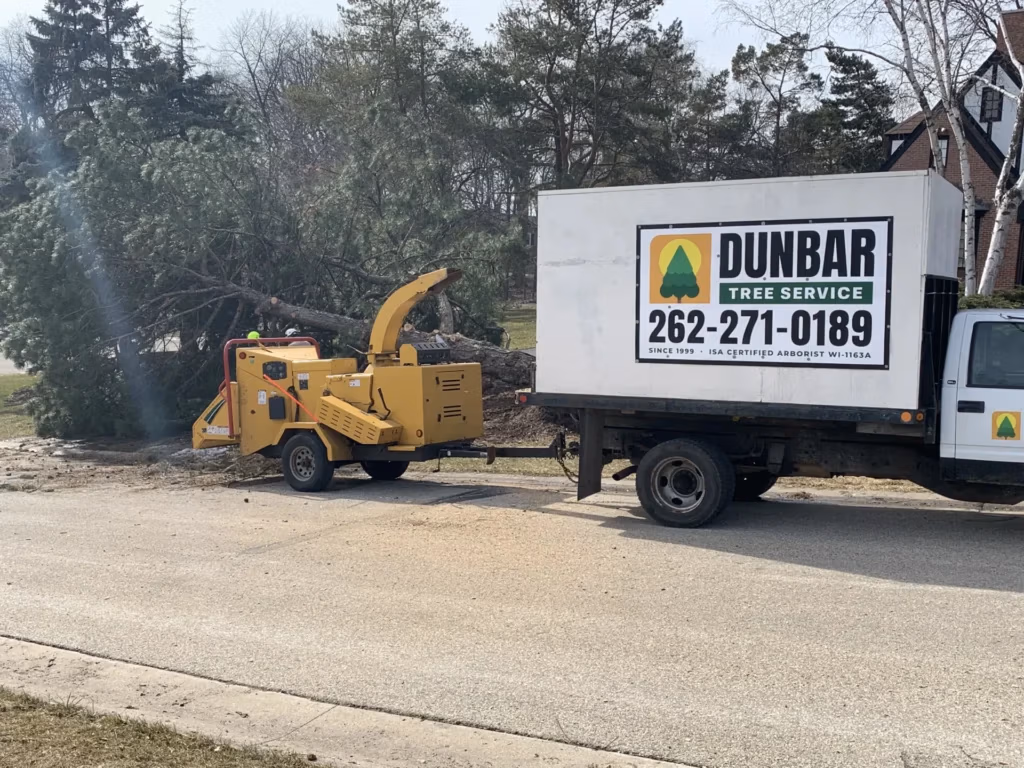 Dunbar Tree Service truck and wood chipper at a tree removal job in Waukesha County,